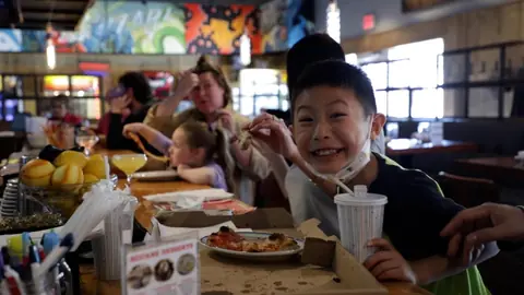Families and friends dining together at Square Peg
