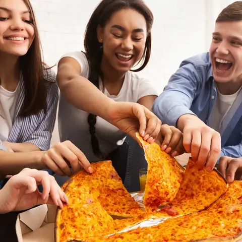 Friends sharing a Square Peg pizza